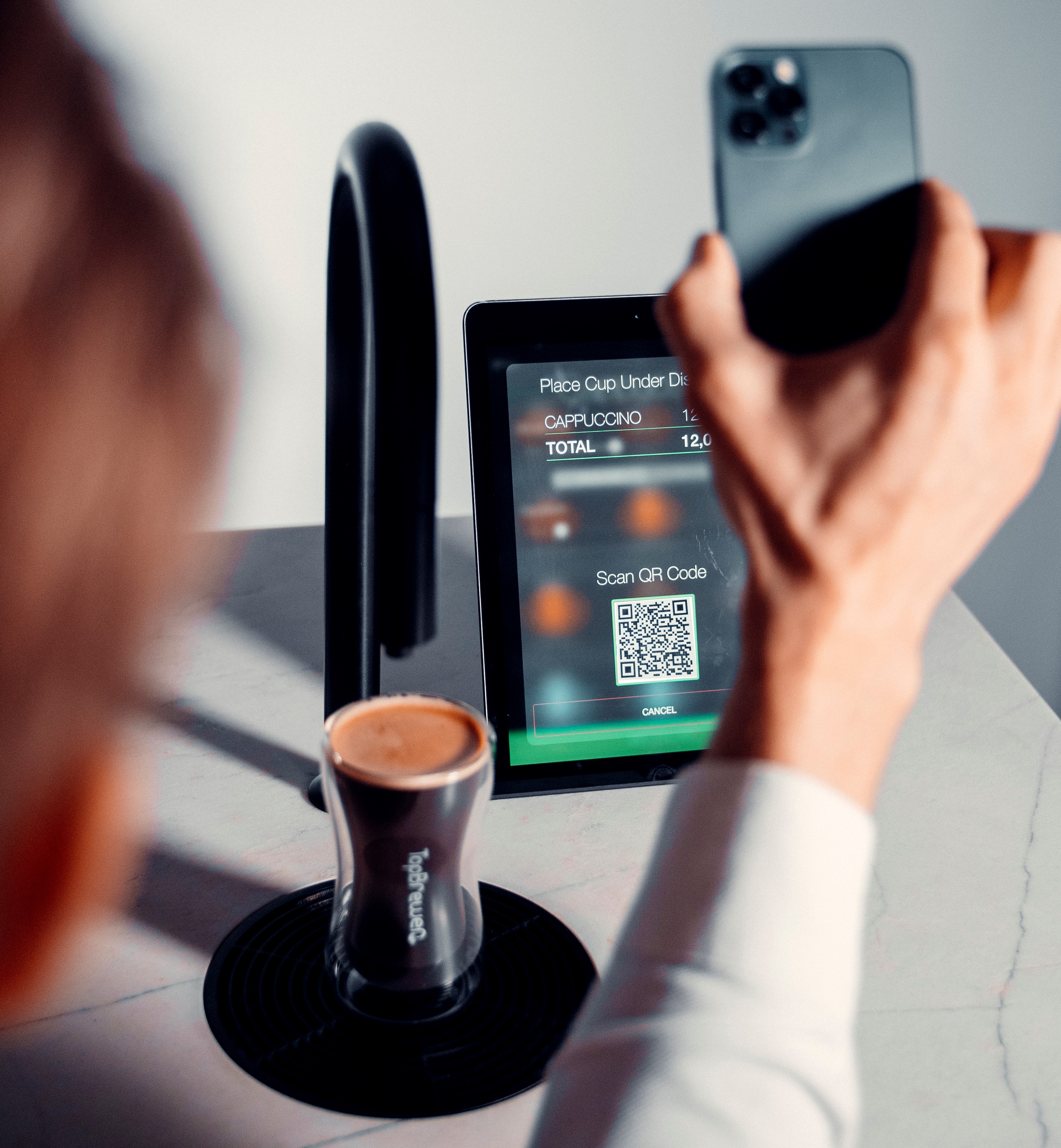A member making a coffee by scanning QR code